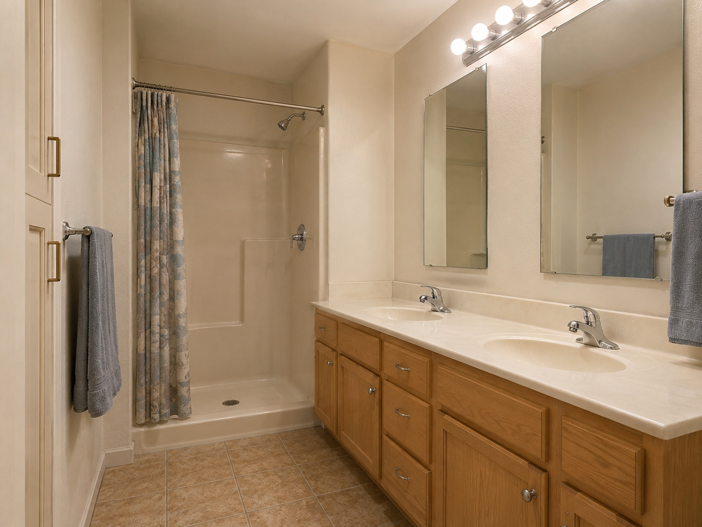 Bathroom remodel before with dated tile, framed shower, and old vanity